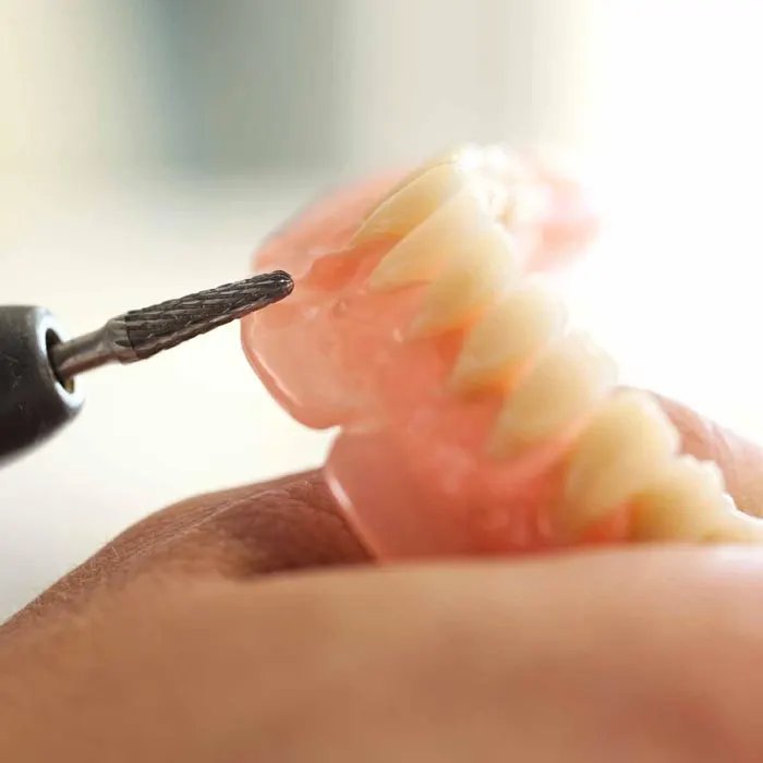Dental technician repairing a denture Denture Care Berkhamsted